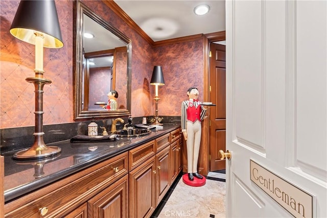 bathroom with crown molding and vanity