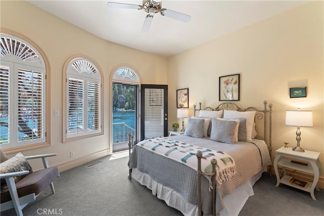 carpeted bedroom featuring multiple windows, access to outside, and ceiling fan