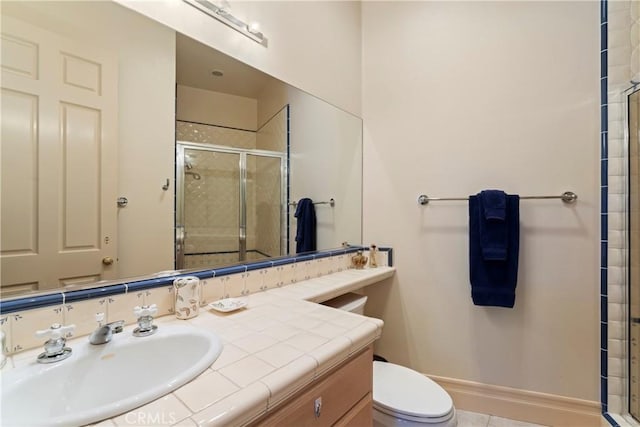 bathroom with vanity, toilet, and a shower with shower door