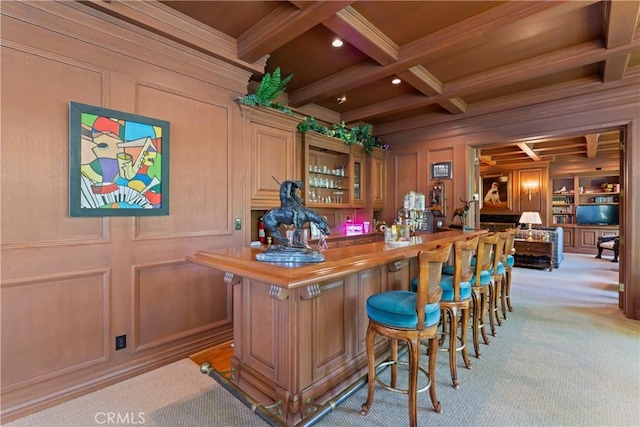 bar with beam ceiling, coffered ceiling, wooden counters, crown molding, and light carpet