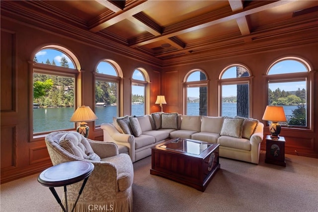 carpeted living room featuring a water view, wooden ceiling, coffered ceiling, and ornamental molding