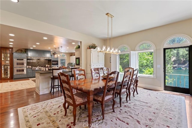 dining space with wood-type flooring