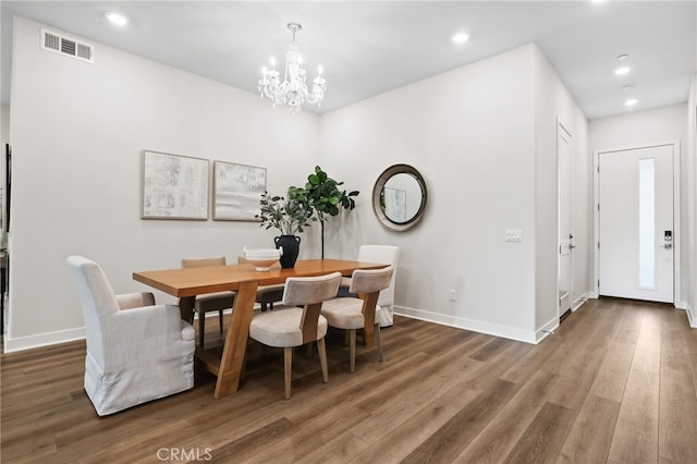 dining space featuring a chandelier and dark wood-type flooring