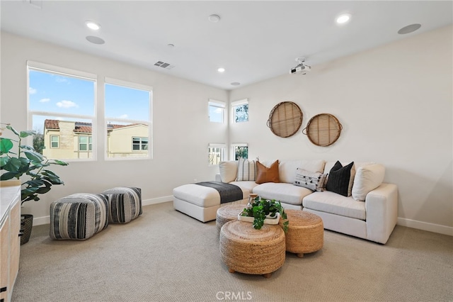 living room with a healthy amount of sunlight and light colored carpet