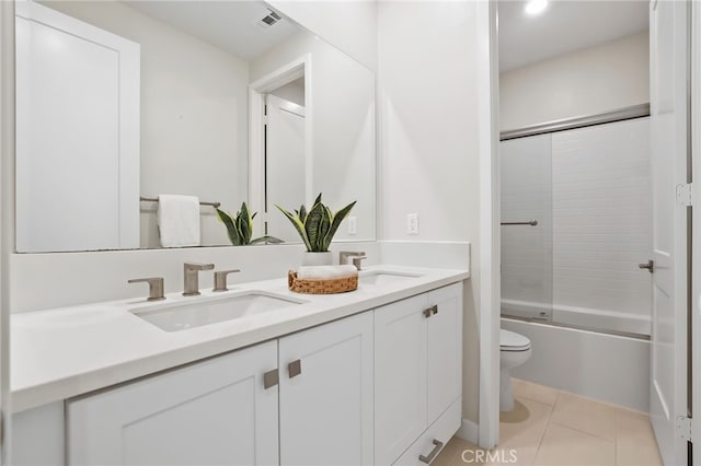 full bathroom featuring tile patterned flooring, vanity, toilet, and enclosed tub / shower combo