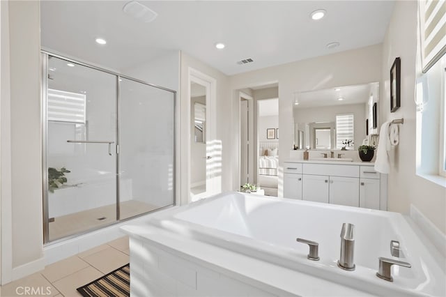 bathroom featuring tile patterned flooring, vanity, and plus walk in shower