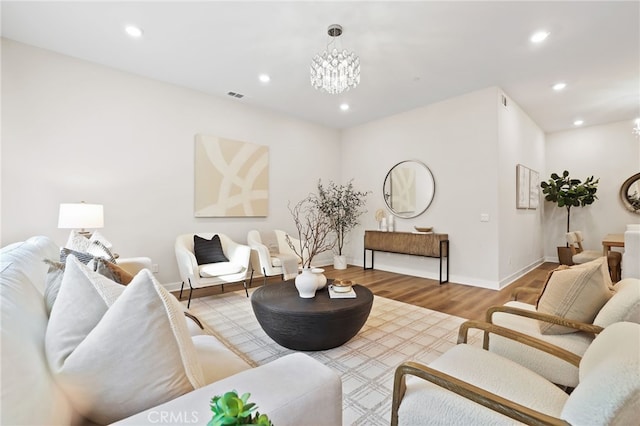 living room with a chandelier and wood-type flooring