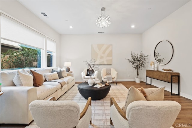 living room featuring a notable chandelier and light hardwood / wood-style flooring