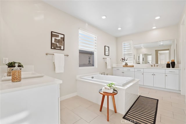 bathroom with tile patterned flooring, vanity, and a washtub