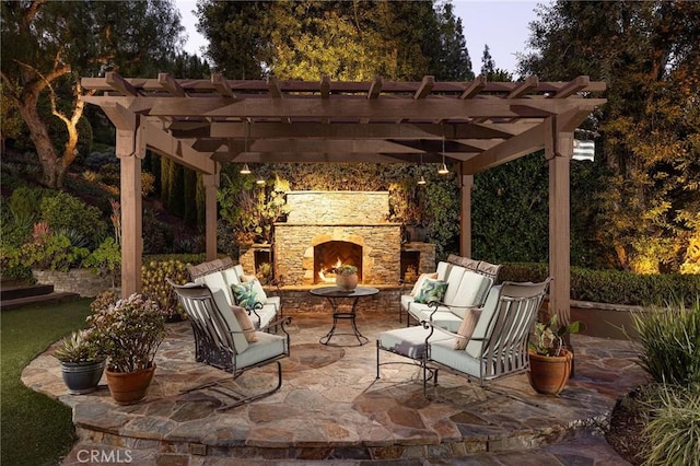 view of patio / terrace with an outdoor living space with a fireplace and a pergola