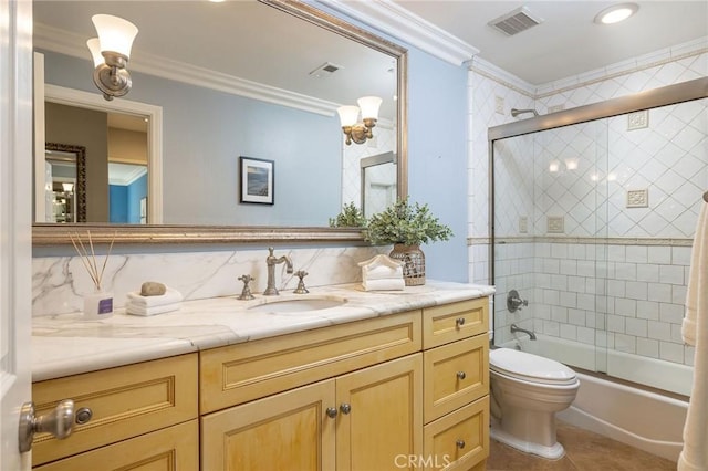 full bathroom featuring vanity, decorative backsplash, toilet, combined bath / shower with glass door, and crown molding