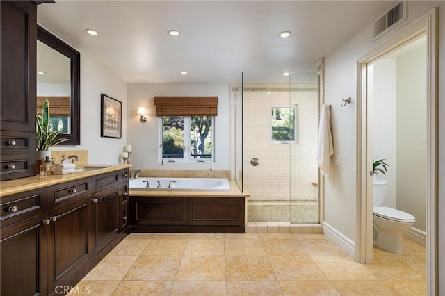 full bathroom featuring vanity, toilet, separate shower and tub, and tile patterned flooring