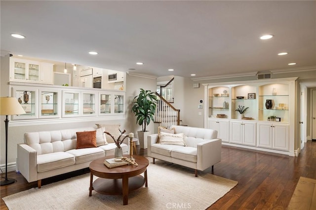 living room with ornamental molding and dark hardwood / wood-style floors