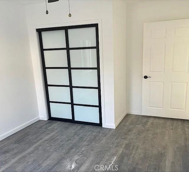 unfurnished room featuring ceiling fan and dark hardwood / wood-style floors