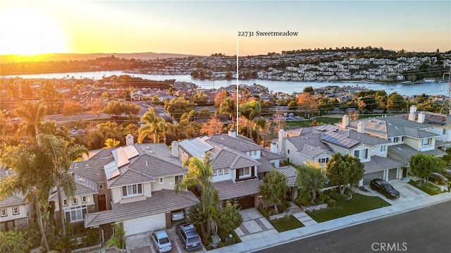 aerial view at dusk with a water view