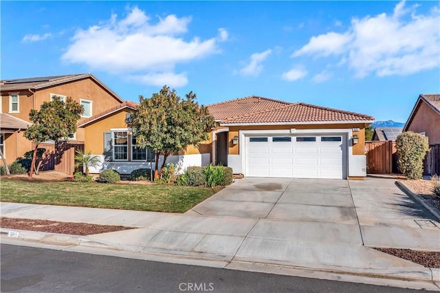 view of front of property with a front yard and a garage