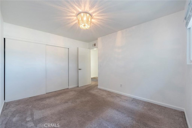 unfurnished bedroom featuring carpet floors and a closet