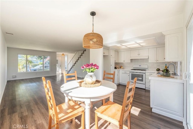 dining area featuring dark hardwood / wood-style flooring and sink