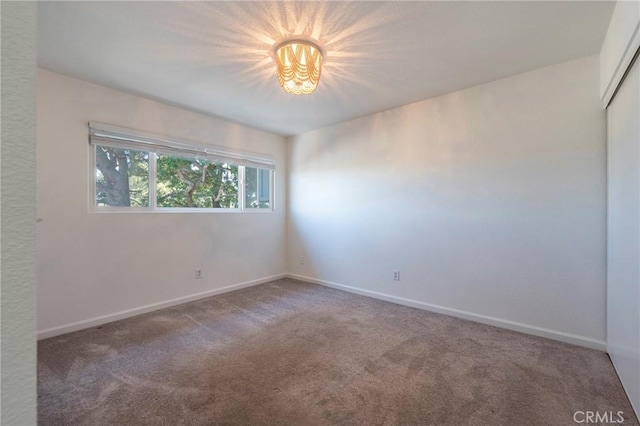 unfurnished room featuring carpet flooring