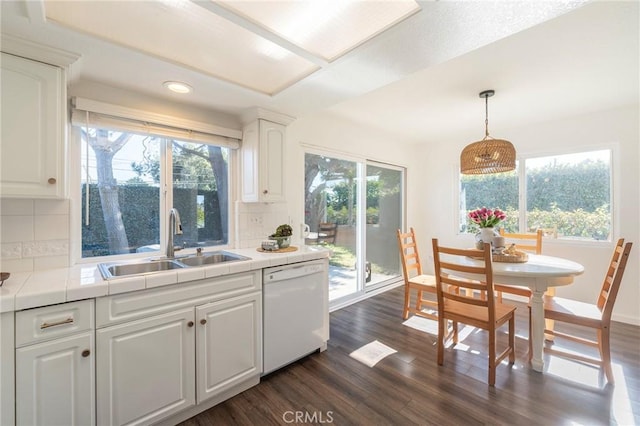 kitchen featuring decorative backsplash, dishwasher, white cabinets, and sink