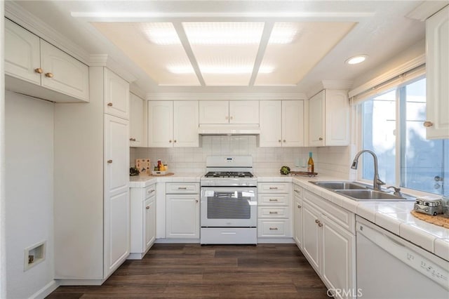 kitchen featuring white appliances, white cabinets, tasteful backsplash, sink, and tile countertops