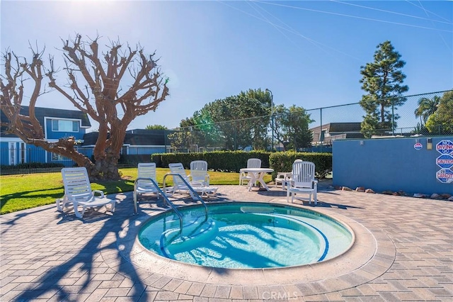 view of pool with a community hot tub and a patio area