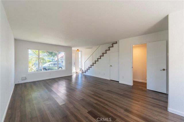 unfurnished living room featuring dark hardwood / wood-style flooring