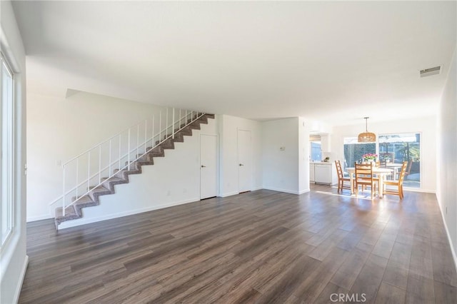 unfurnished living room featuring dark wood-type flooring