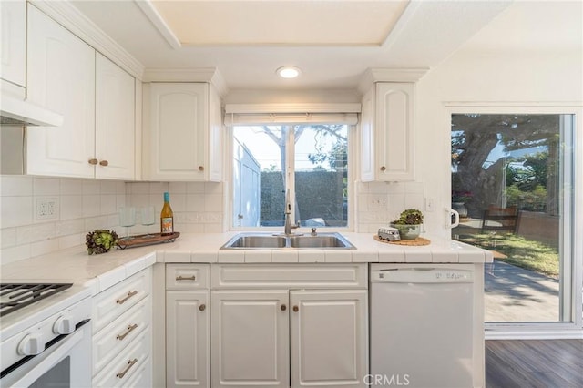 kitchen with sink, white cabinets, and white appliances