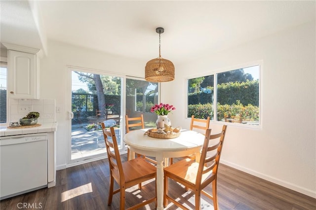 dining space with dark wood-type flooring