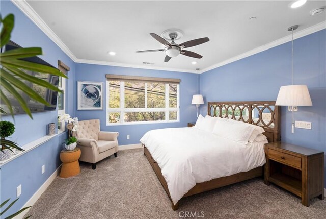 carpeted bedroom featuring ceiling fan and crown molding