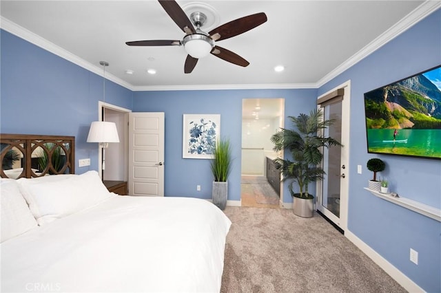 bedroom featuring light colored carpet, ensuite bath, ceiling fan, and ornamental molding