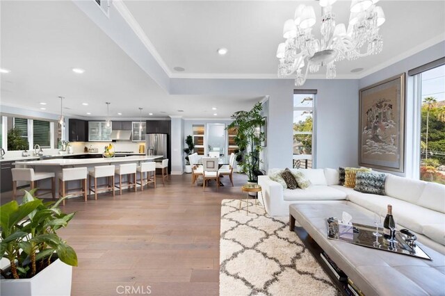 living room featuring crown molding, hardwood / wood-style floors, and plenty of natural light