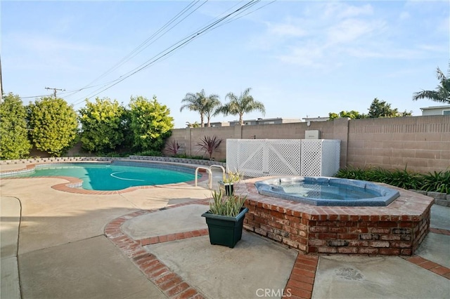 view of pool with an in ground hot tub and a patio area