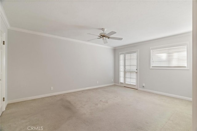 carpeted spare room featuring crown molding and ceiling fan