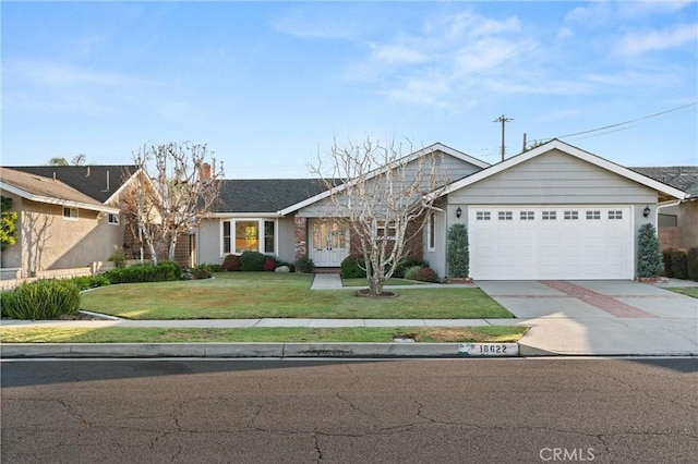 ranch-style home with a garage and a front lawn