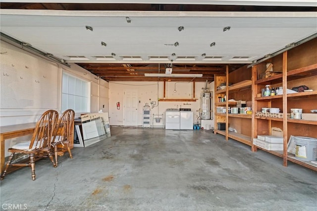 garage with separate washer and dryer and water heater