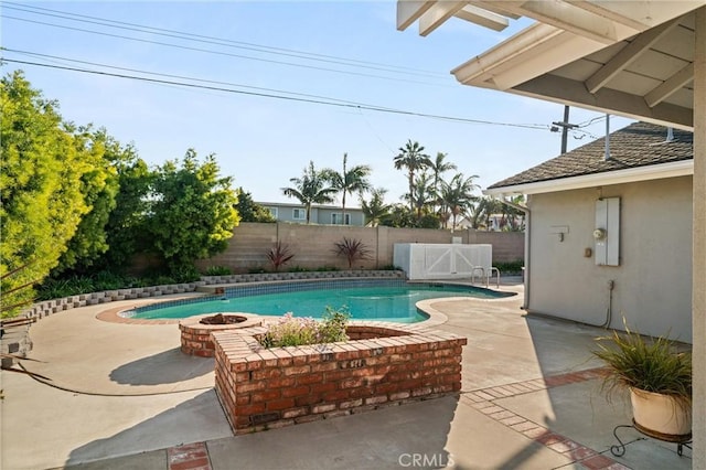 view of pool featuring an outdoor fire pit and a patio