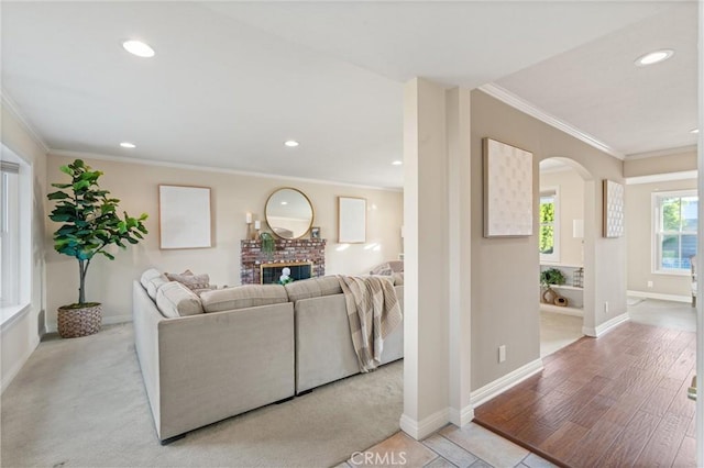 living room featuring light wood-type flooring and ornamental molding