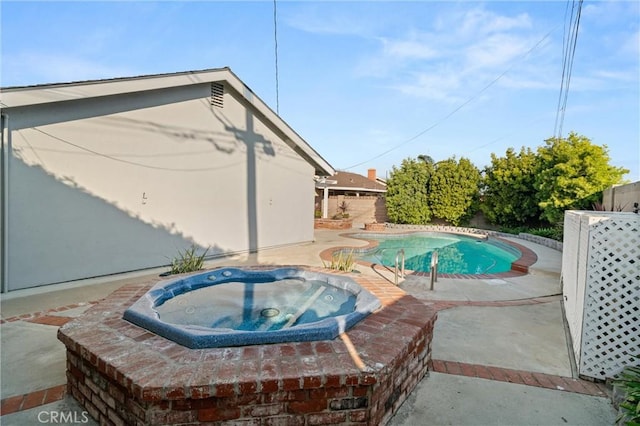 view of swimming pool featuring an in ground hot tub and a patio area