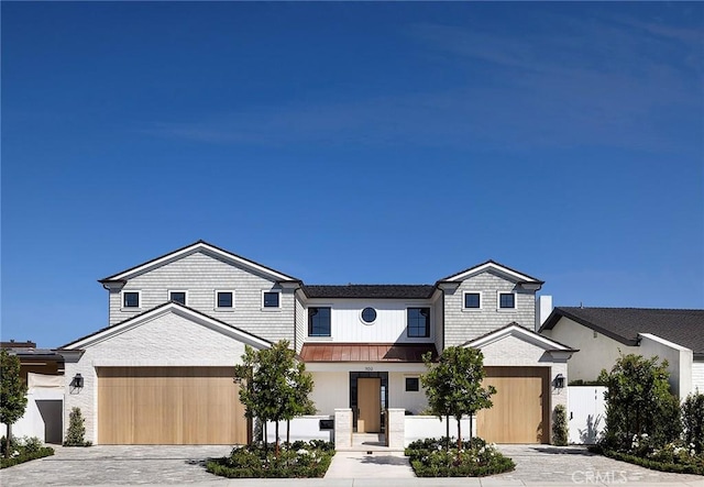 702 Saint James Pl, Newport Beach, CA 92663 - townhome / multi-family property with driveway, a standing seam roof, an attached garage, and a metal roof