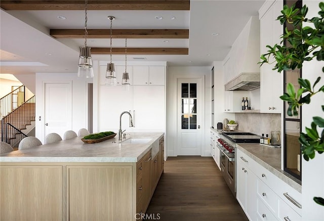 702 Saint James Pl, Newport Beach, CA 92663 - kitchen featuring double oven range, premium range hood, dark wood-type flooring, a center island with sink, and decorative backsplash
