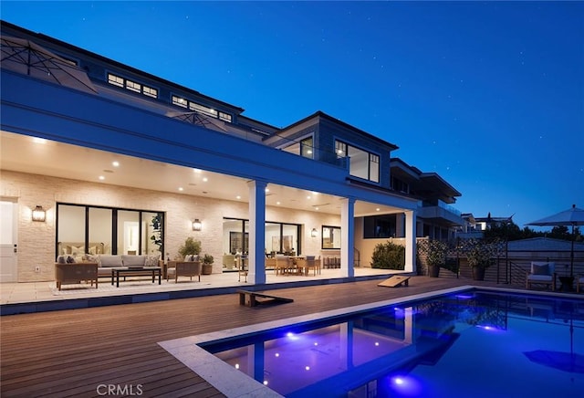 702 Saint James Pl, Newport Beach, CA 92663 - back of house at night featuring an outdoor living space, a deck, and outdoor dining space