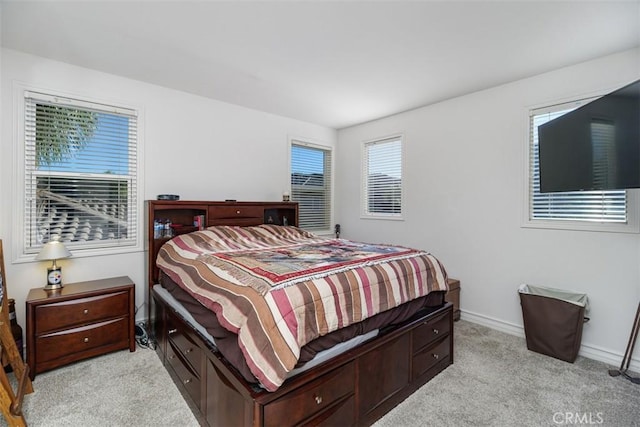 bedroom featuring light colored carpet