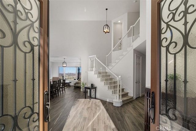 entryway with a notable chandelier and dark wood-type flooring