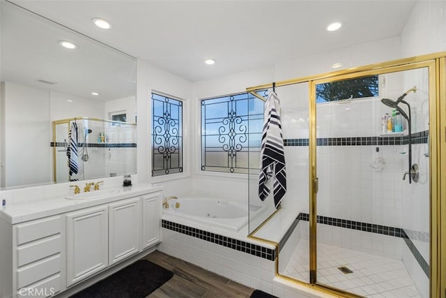 bathroom featuring shower with separate bathtub, vanity, and hardwood / wood-style flooring