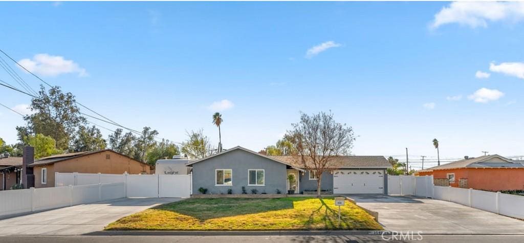 single story home featuring a front yard and a garage