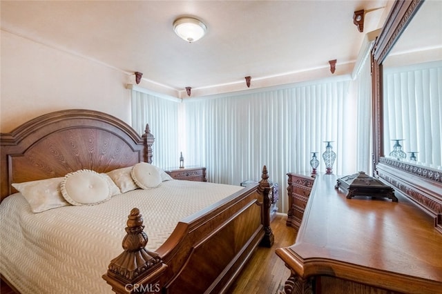 bedroom with dark wood-type flooring