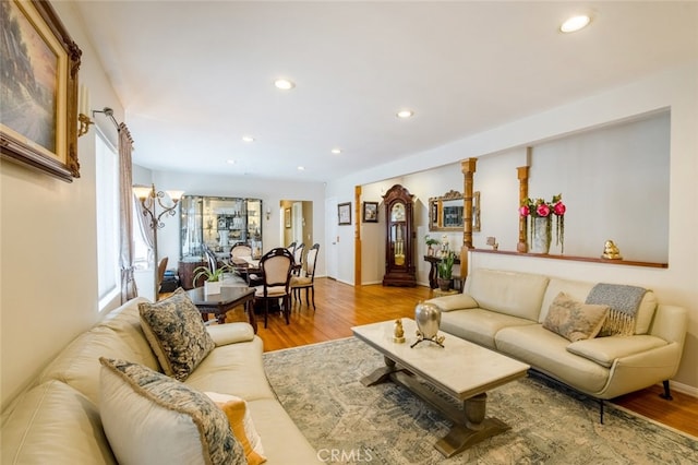 living room with light wood-type flooring and an inviting chandelier