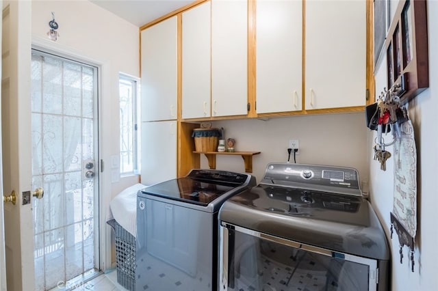 laundry area with cabinets and independent washer and dryer